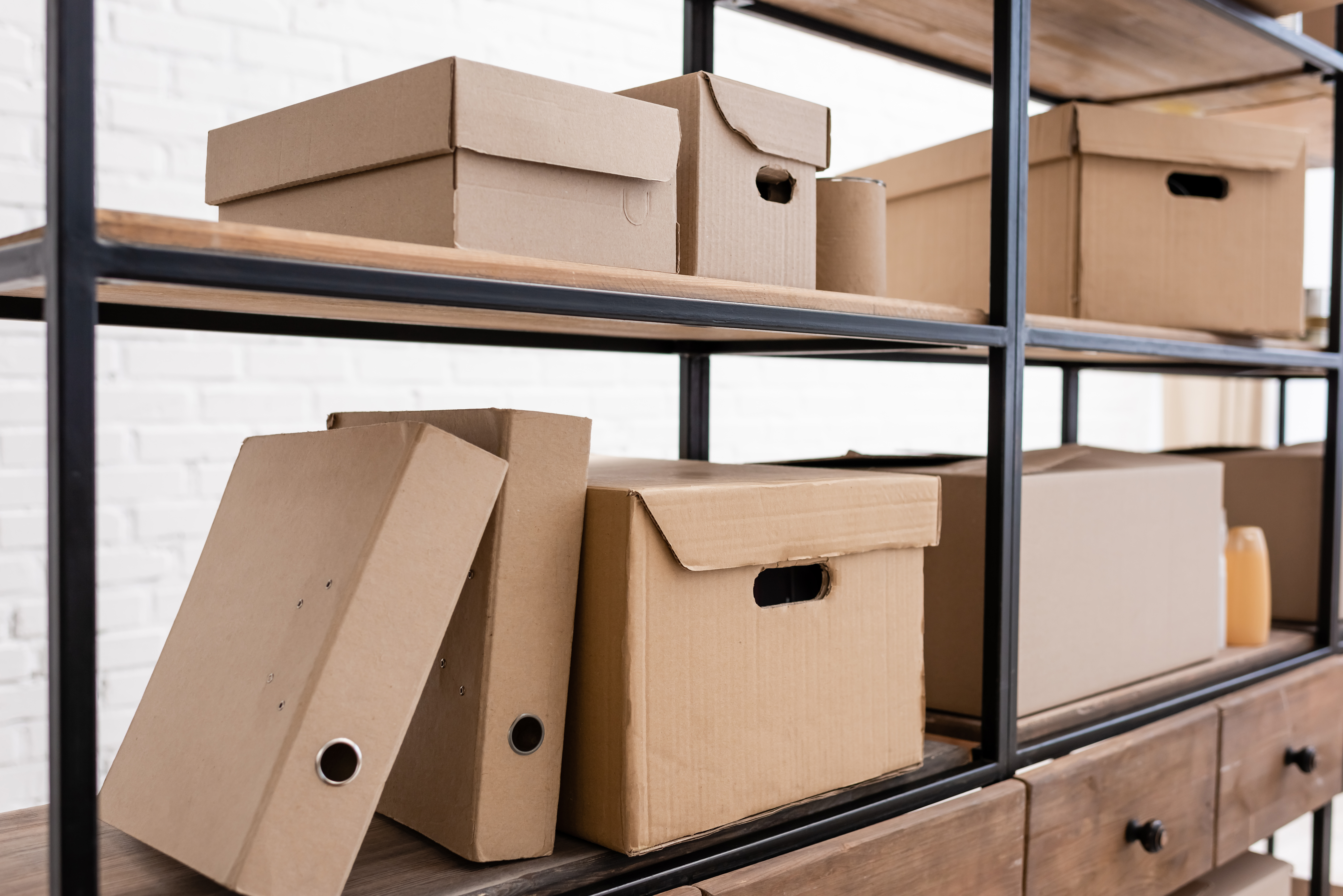 A shelving unit inside a self storage facility showing box organization with Access Storage, IN